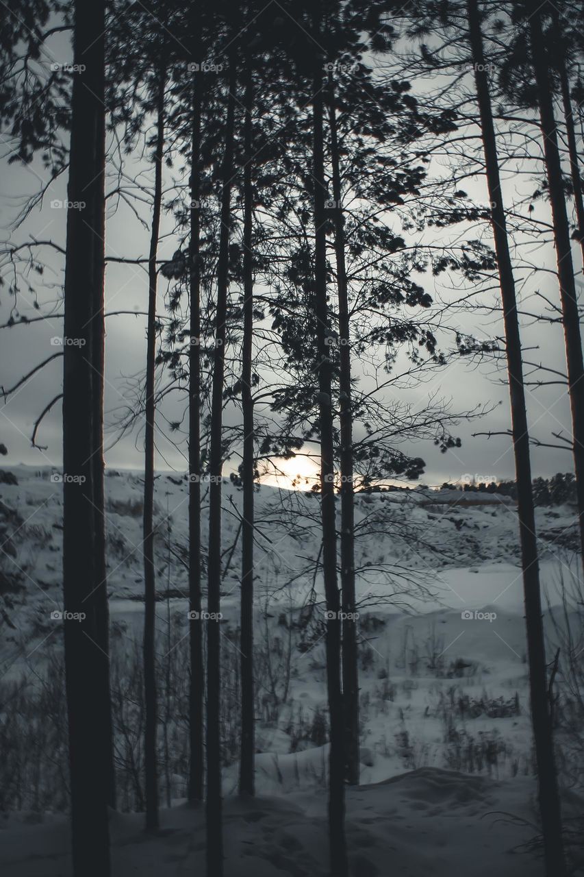 The sun gradually comes out from behind the hill