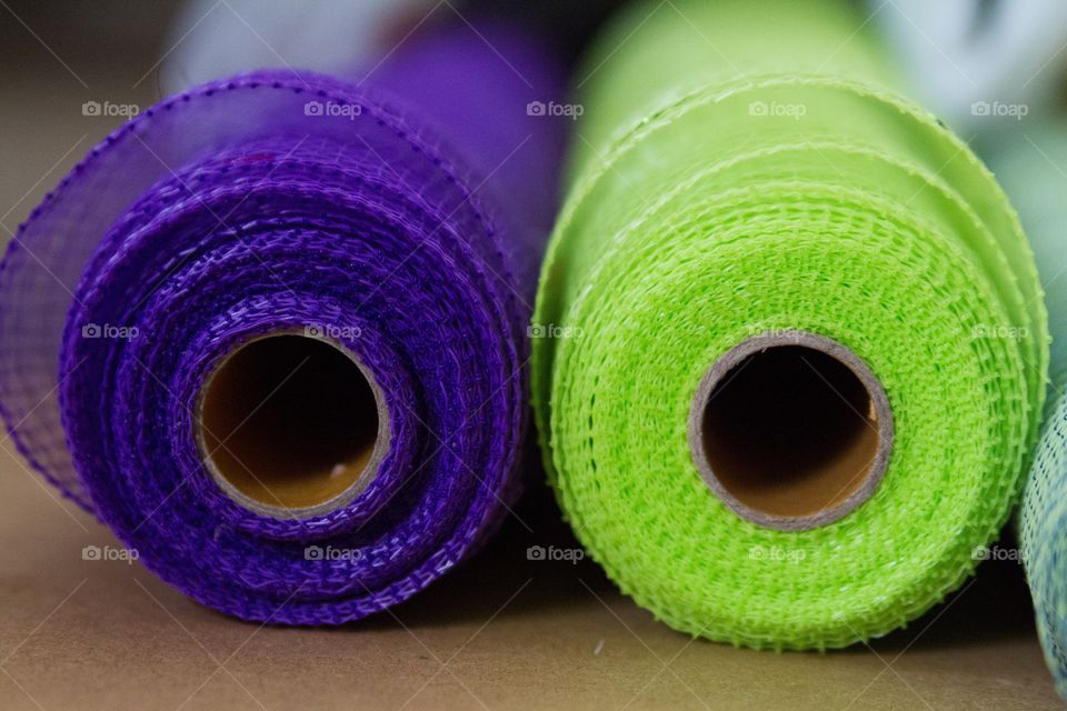 Tube view of two mesh fabric rolls