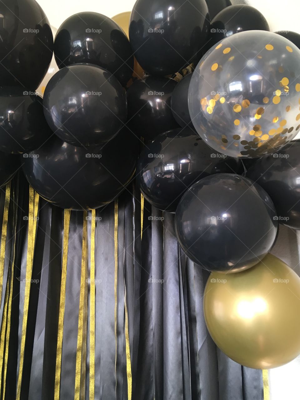 Party balloons and ribbon black and gold photo background