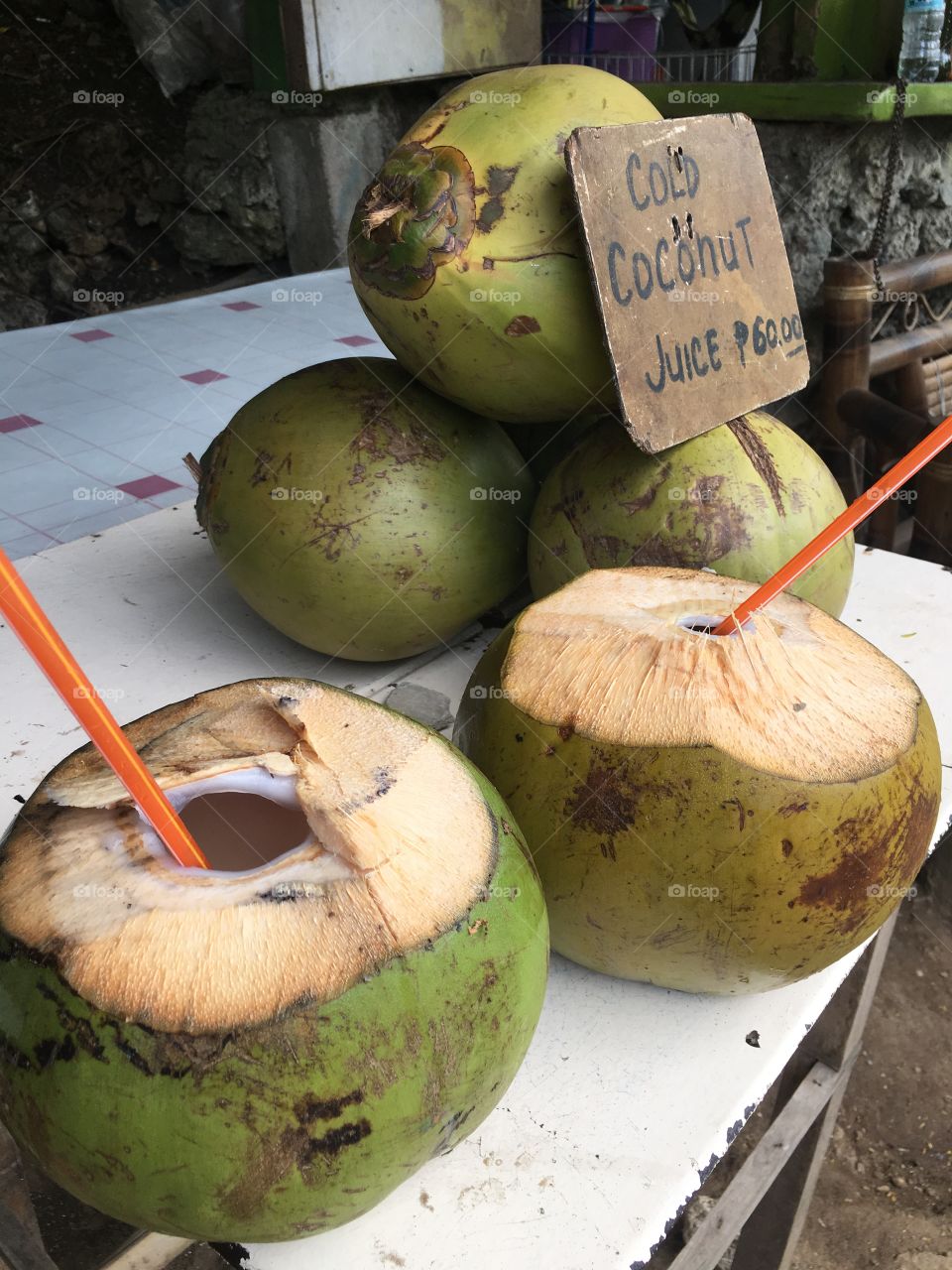 Fresh, green coconuts on sale by the roadside. 