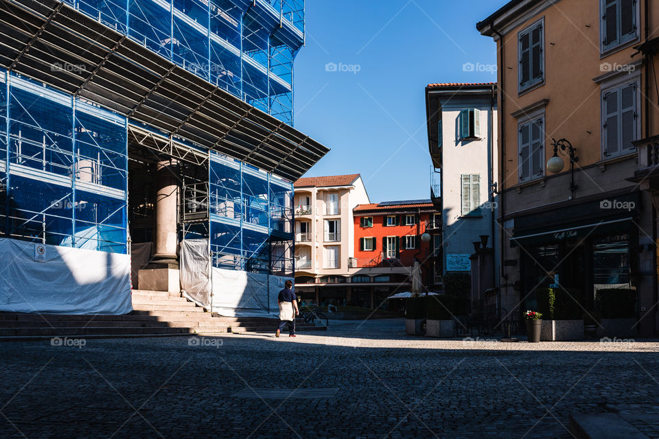 Man strolling in front of the church of Verbania