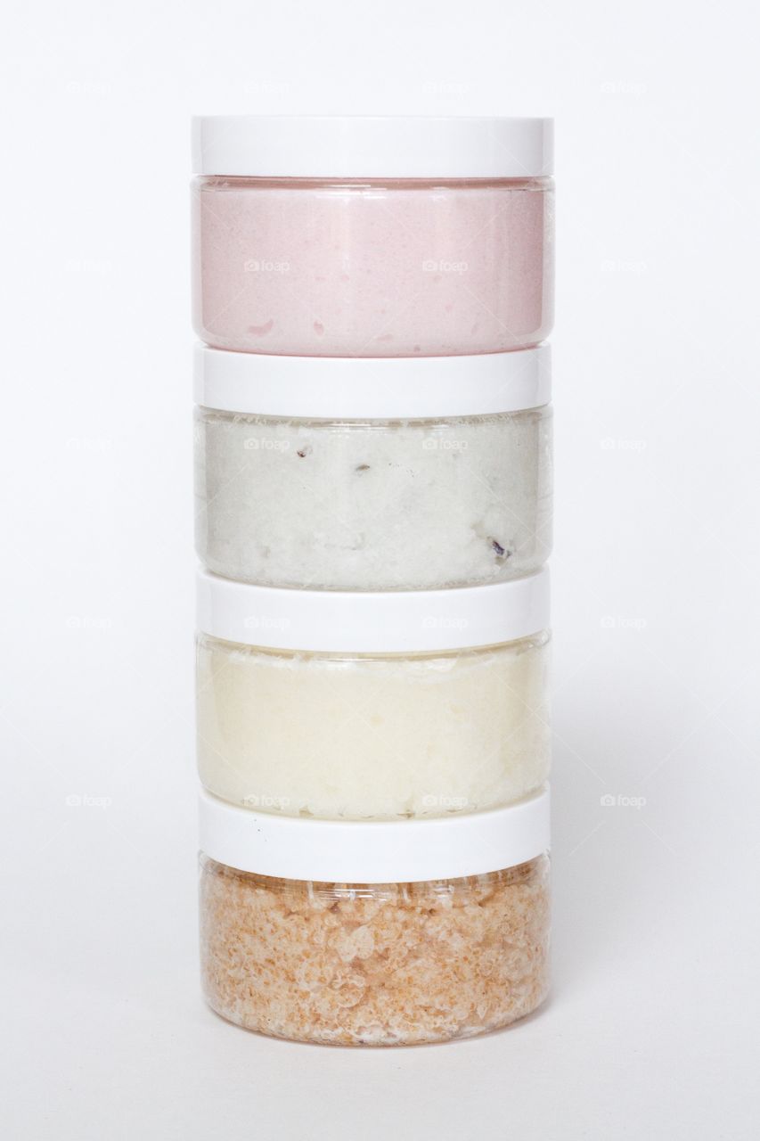 Vertical stack of handmade bath scrubs in a variety of natural colours 