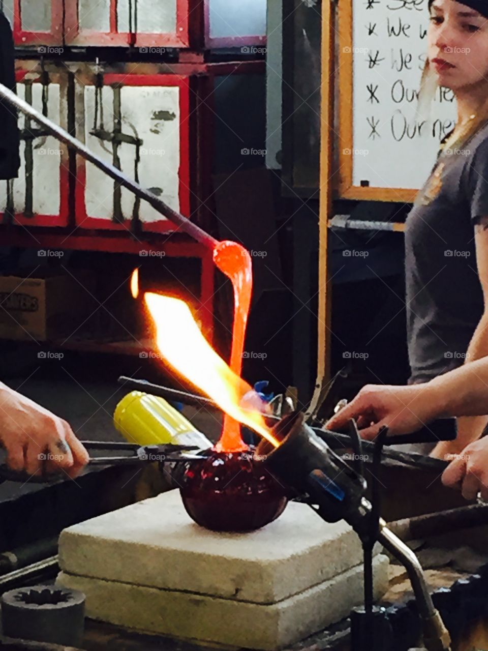 Glass blowing up close. Artisans creating glass pumpkins