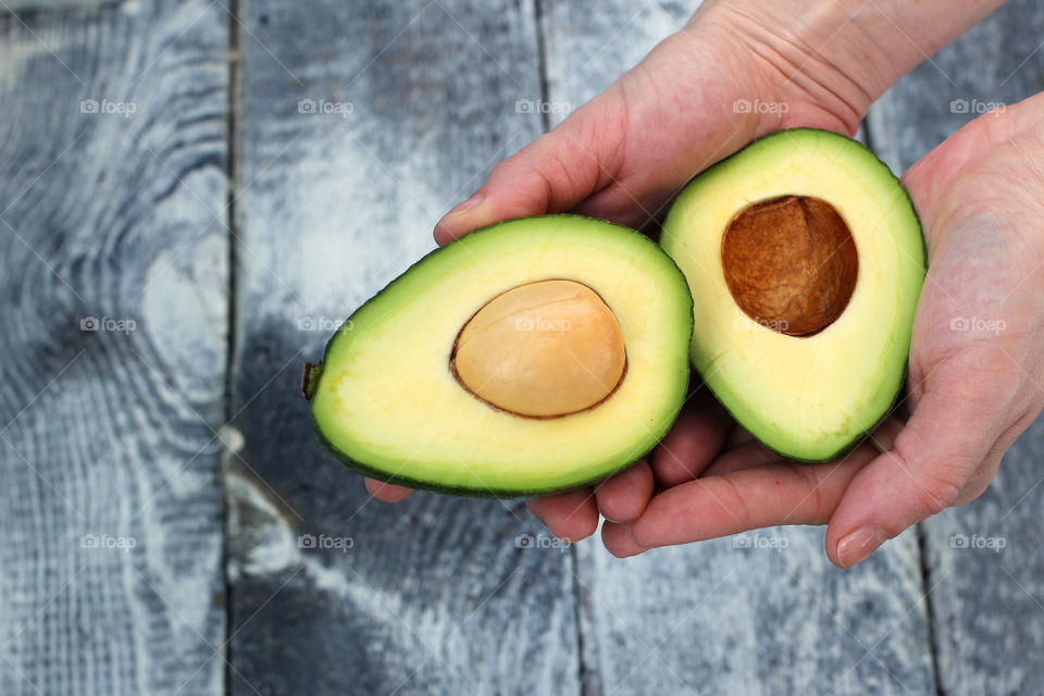 Hands, female hands, avocado in hands, avocado, fruit, food, abstraction, still life