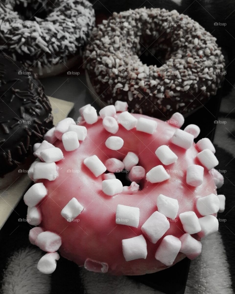 Sweet home indoor food yummy served table day part form circle ellipce tasty pink dark donut view