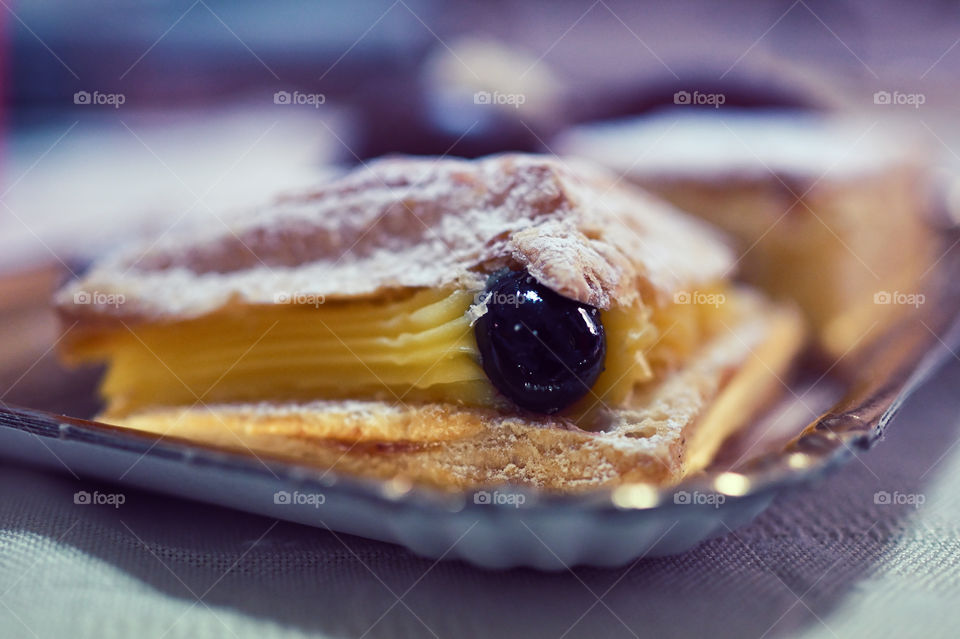 Cream cake made of puff pastry with cherry