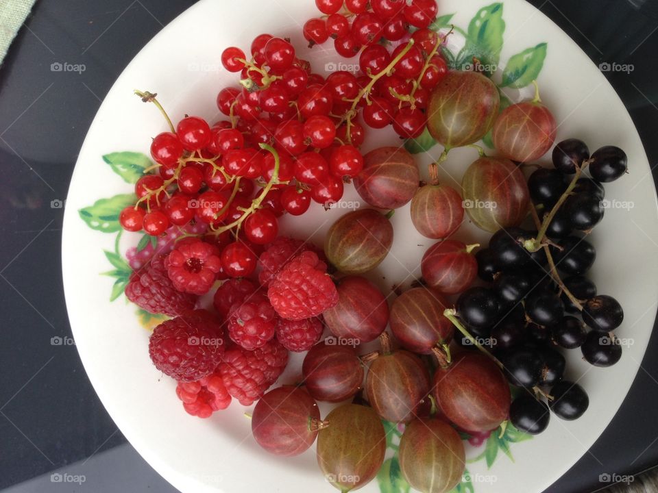 Berries from the garden. Raspberry, black currant, red currant, gooseberry 
