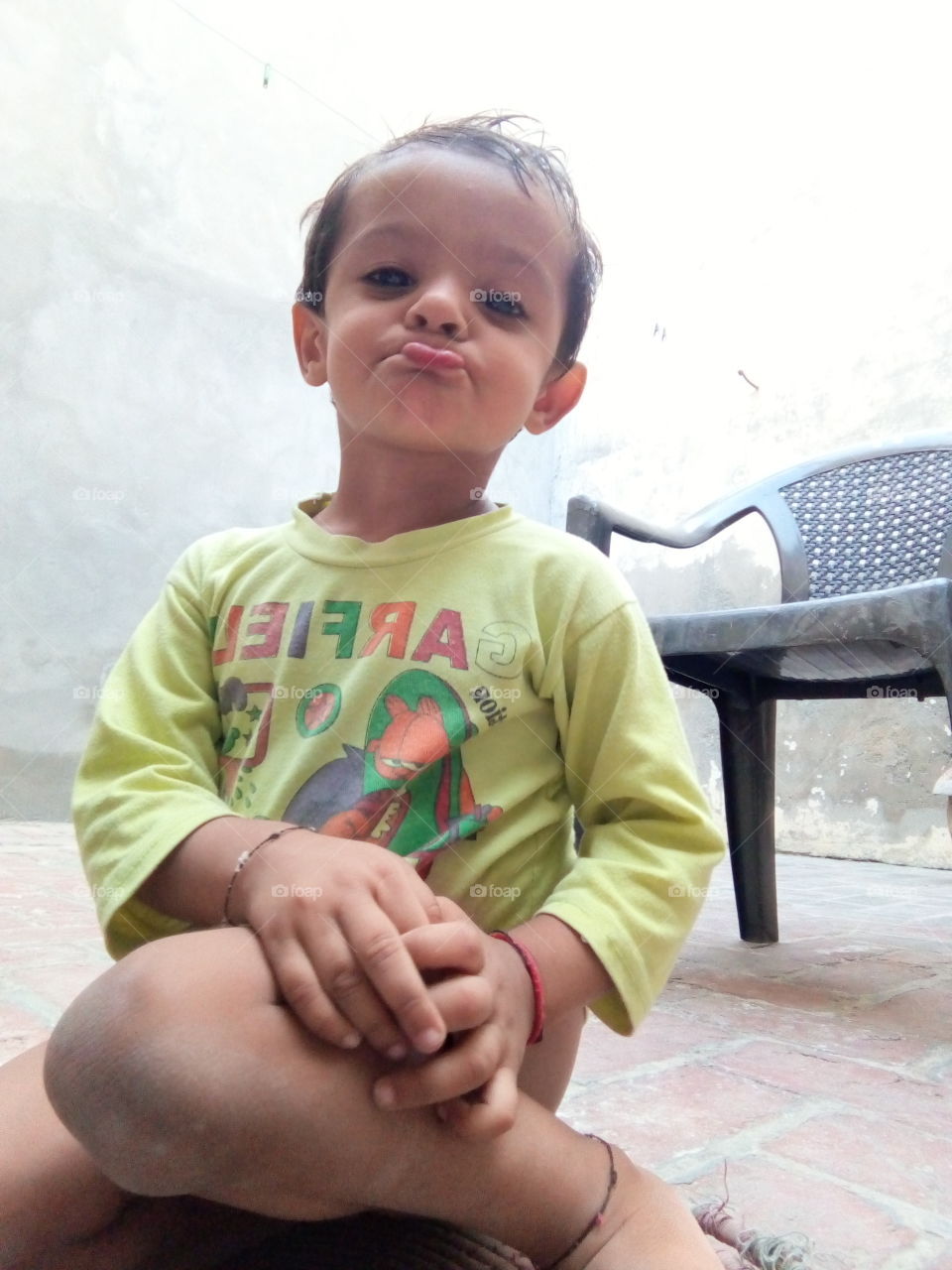 a little boy making his mouth.