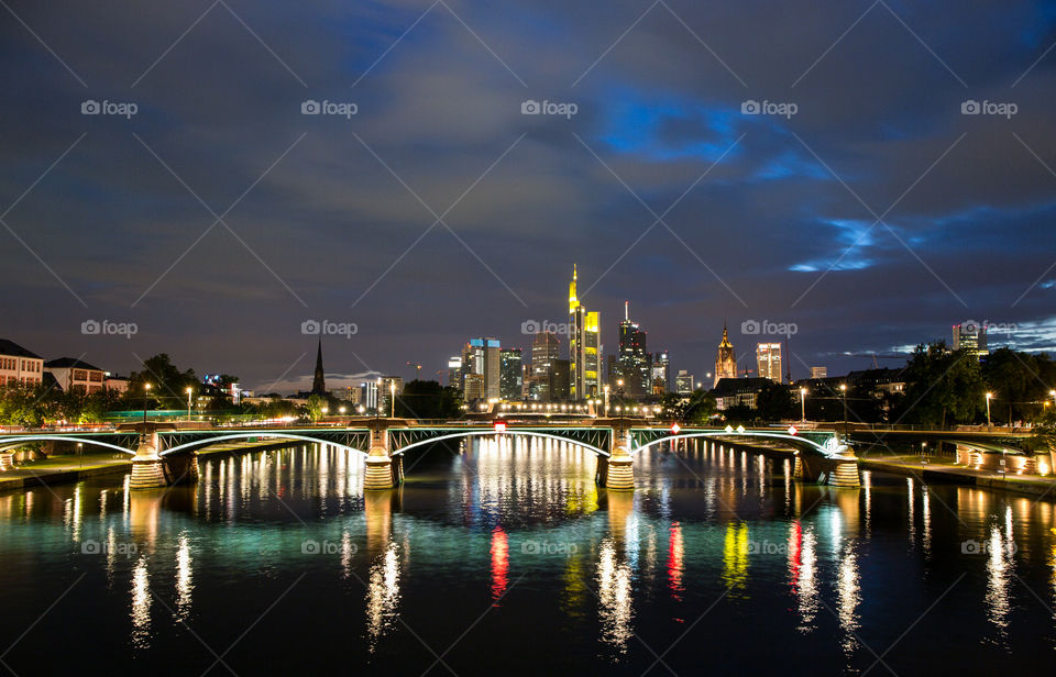 Frankfurt skyline by night with the Main river and bridges