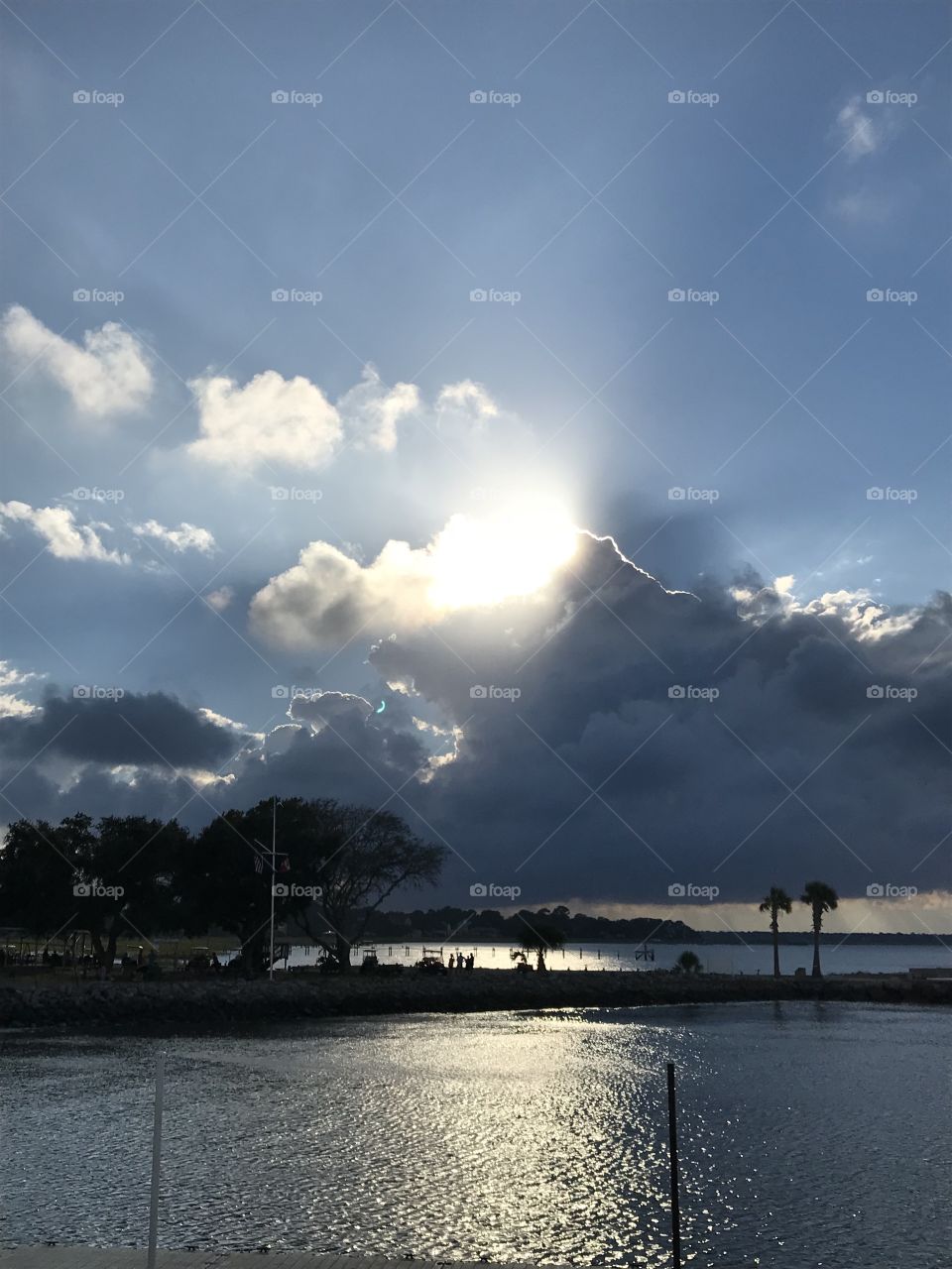 Evening clouds swallowing the sun across the harbor