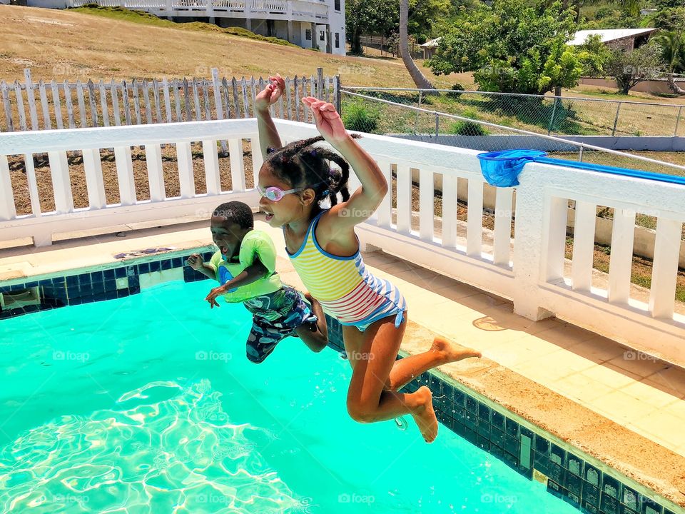 Kids jumping in pool 