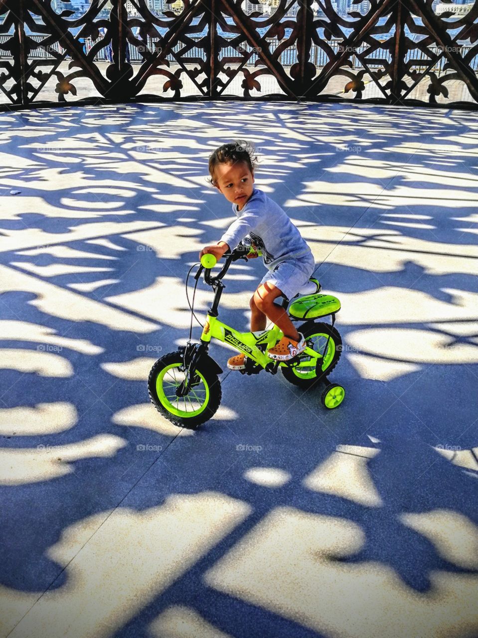 Boy riding bike in shadow ornaments