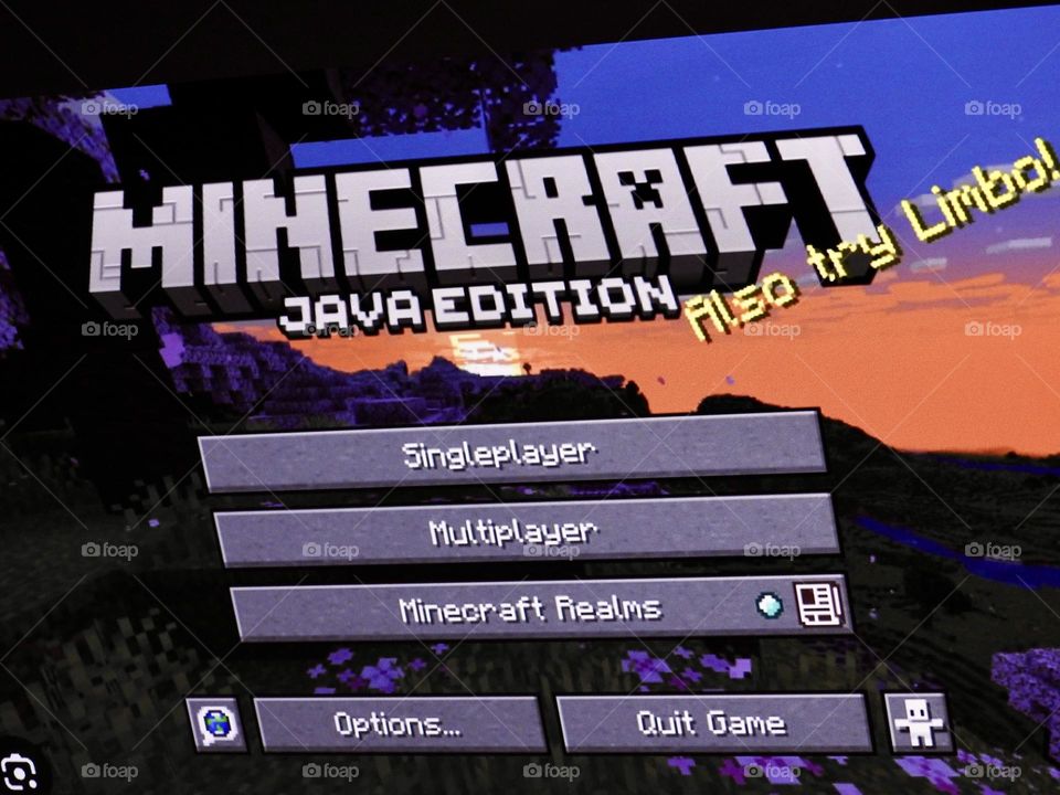 Video game photography taken of the game Minecraft from a gaming computer screen in a dark room at the start of the game showing the menu from the start.