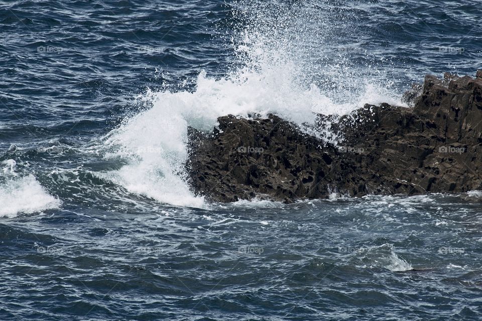 waves crashing on rocks