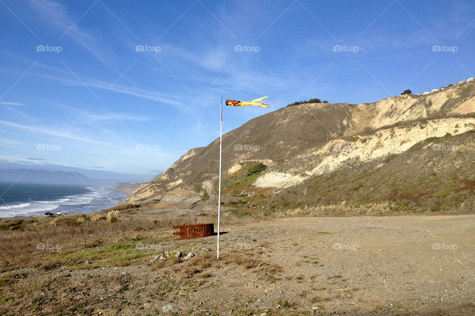 Windsock swaying at slightly elevated place near beach