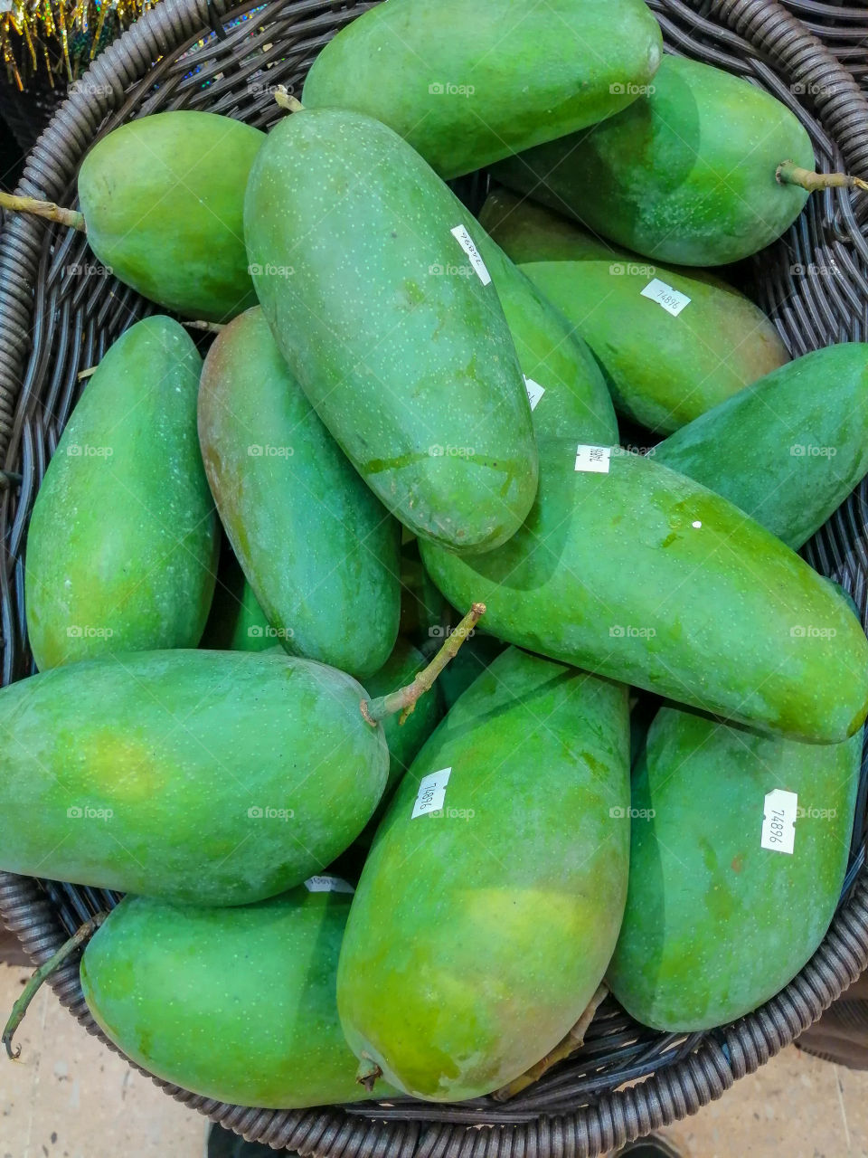 Green mangoes in a basket