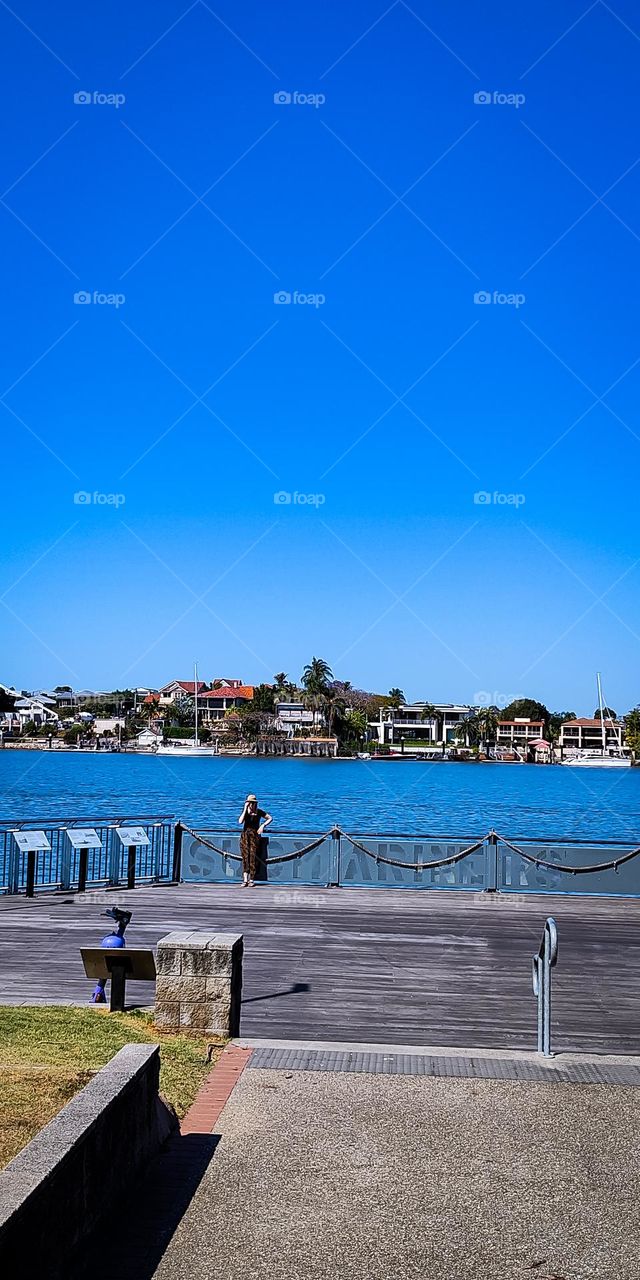 Woman enjoying a bright sunny day by the river