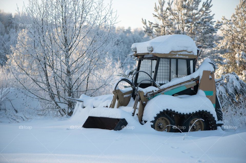 Snow covered tractor