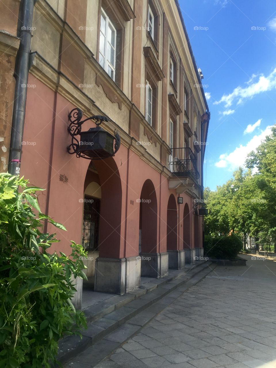 An ancient building with arches in the street