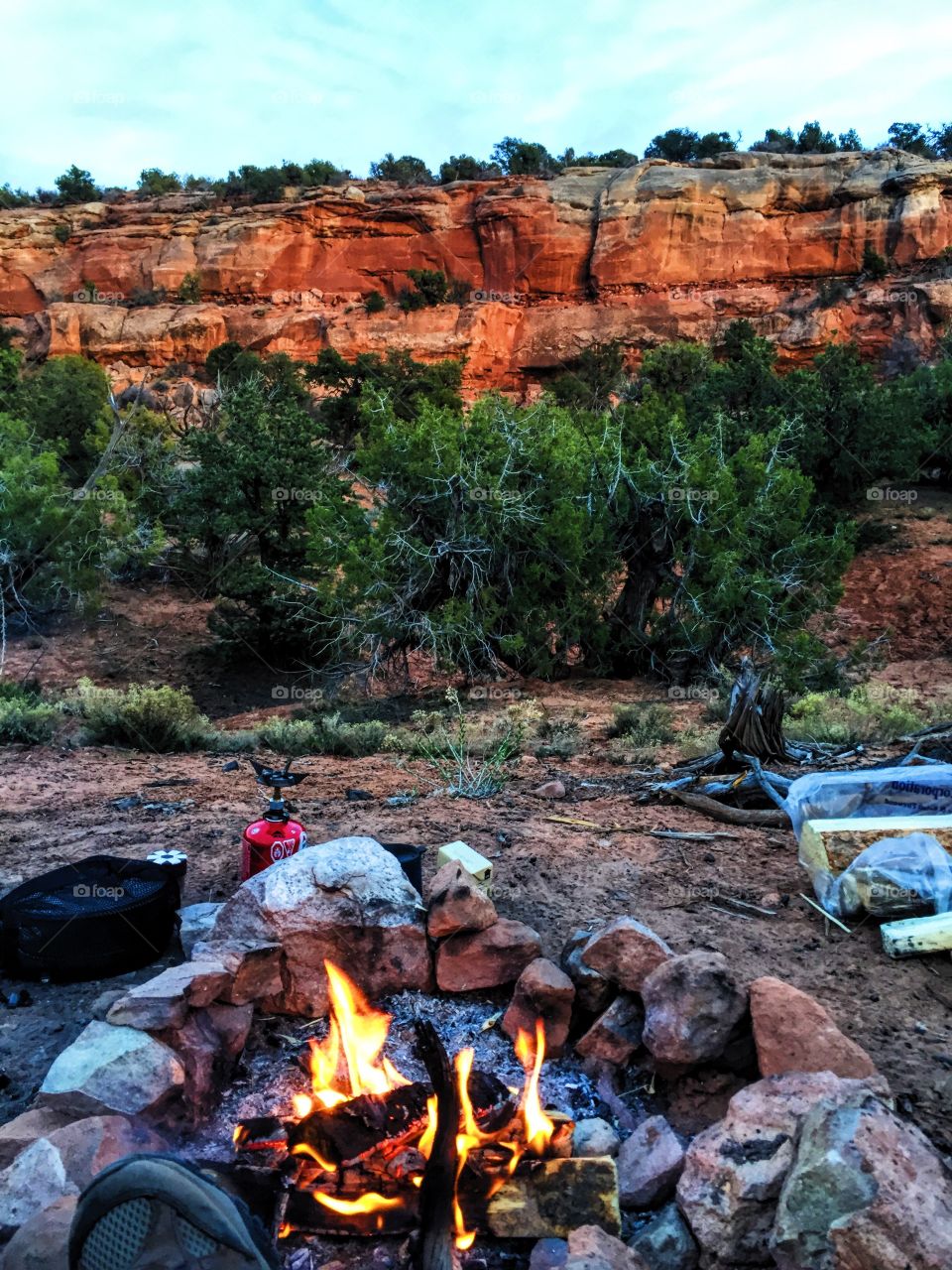 Campfire on field near rocky mountain