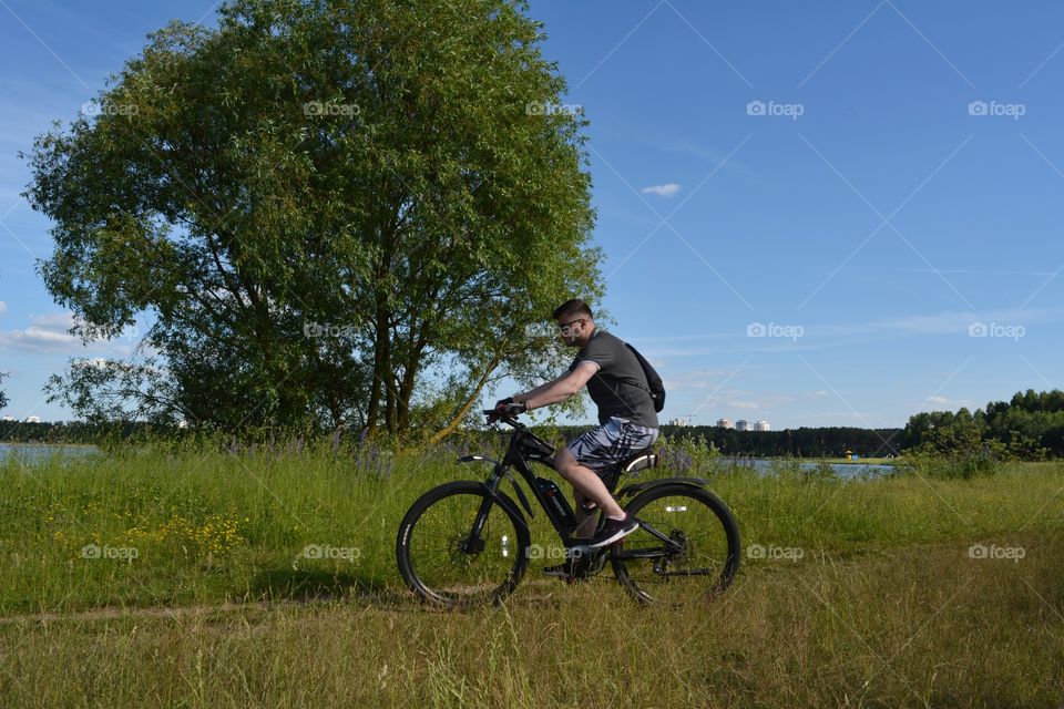 men ridding on a bike summer time