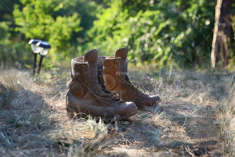 old hiking boots on the grass in forest