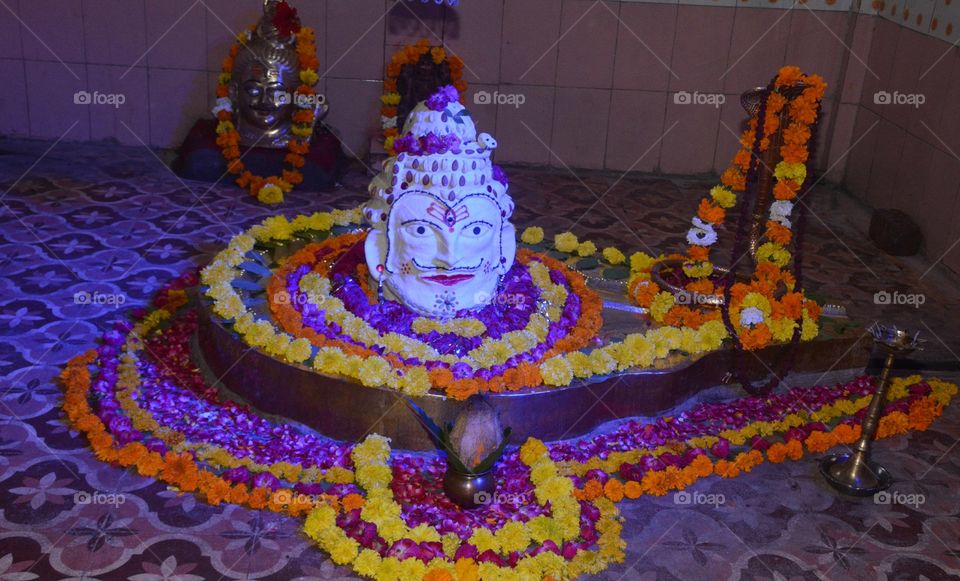 Lord Shiva decorated with flowers and garlands