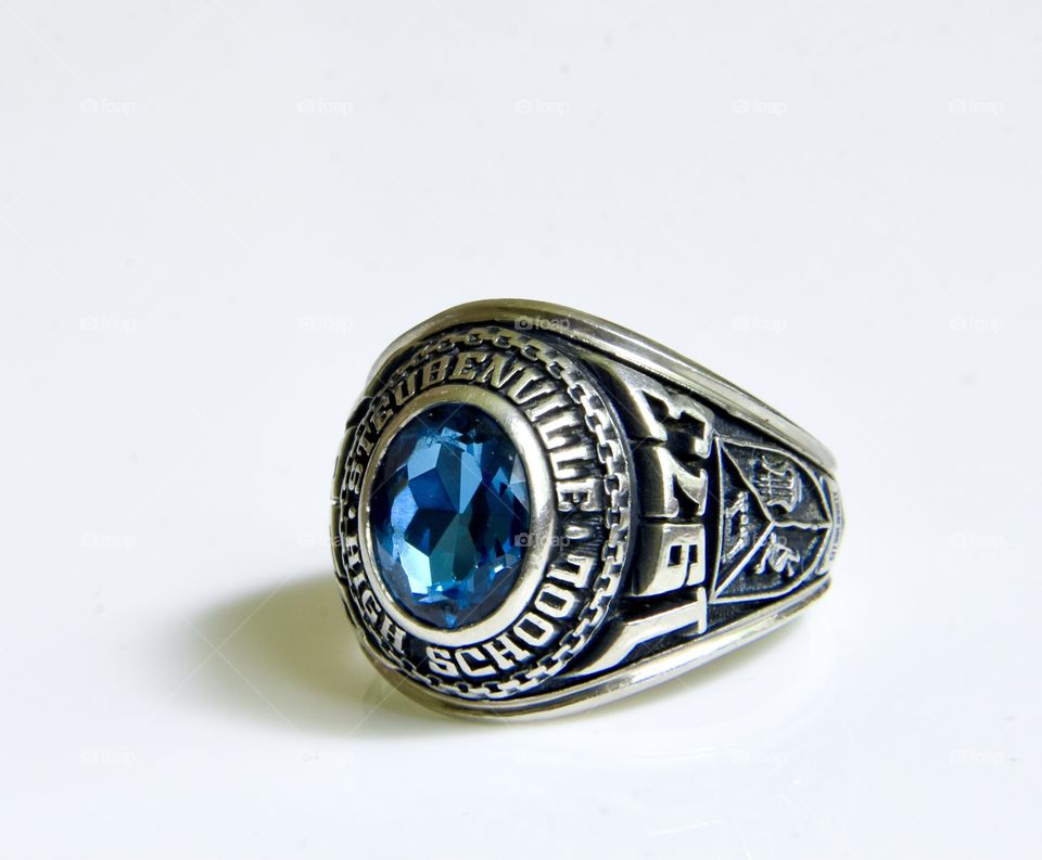 Class ring with blue stone and white gold band