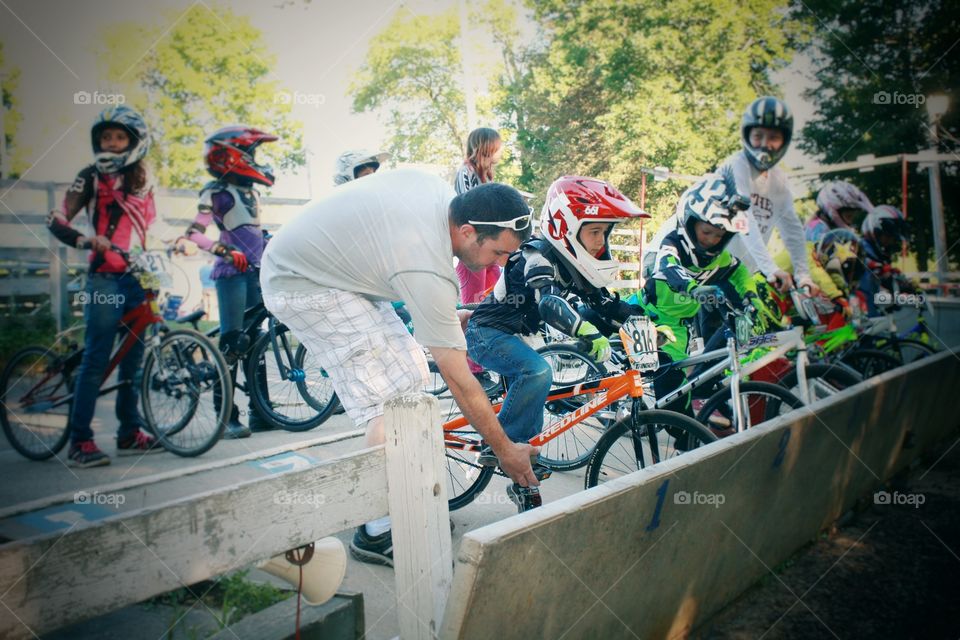 3rd generation BMX racer getting ready for his first race ever with his proud dad by his side. His father was the same age when he started BMX racing. He raced BMX before knowing how to tie his own shoes!