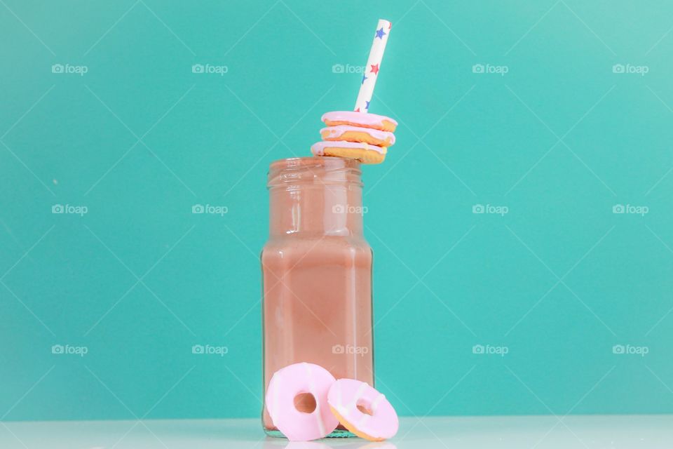 Choccy shake treat. Chocolate milkshake in a glass jar with iced cookies