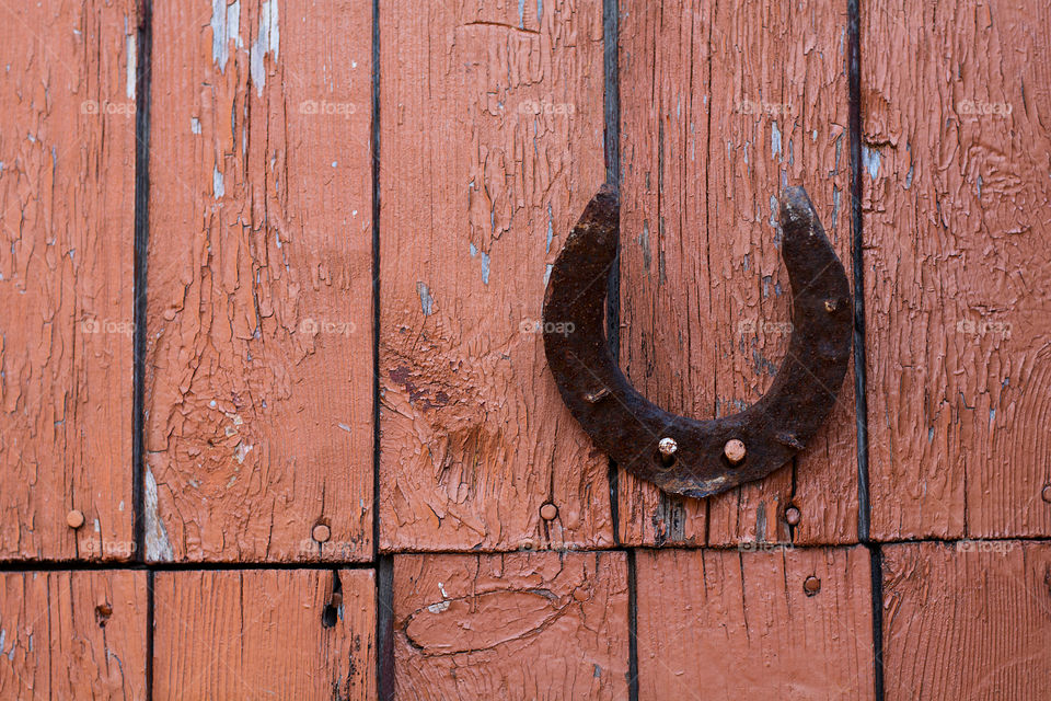 The horseshoe on old wooden door