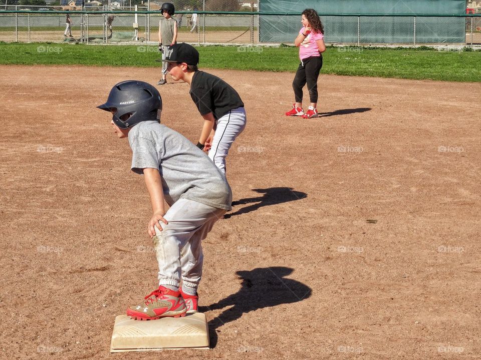 Little League Runner On First Base. Youth Baseball