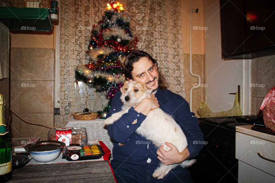 A portrait of a man with the dog at the New Year eve