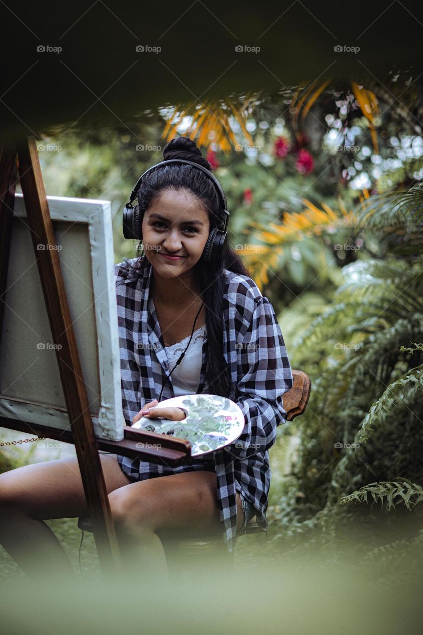 Girl happy to enjoy painting in nature