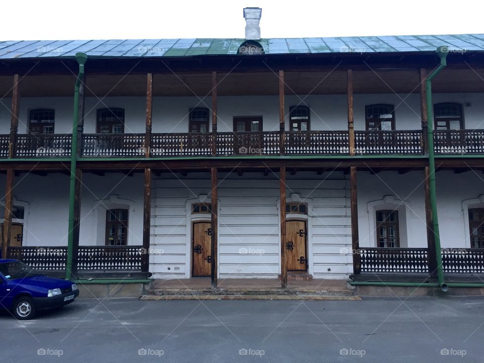 An old 2 floors building with wooden elements on facade