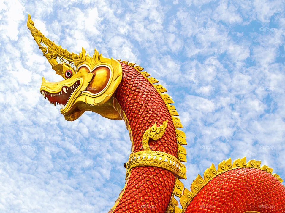 red nagas statue in public temple thailand