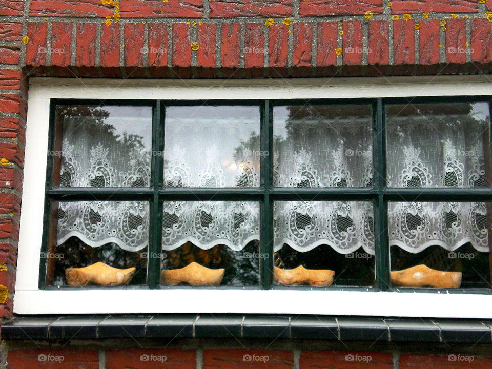 View of dutch clogs on window