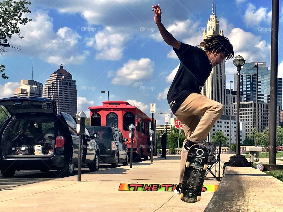 Skateboader doing tricks in the city.