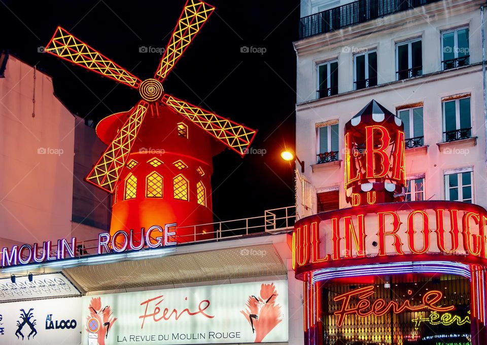 The Moulin Rouge, lit up at night in Monmarte, Paris