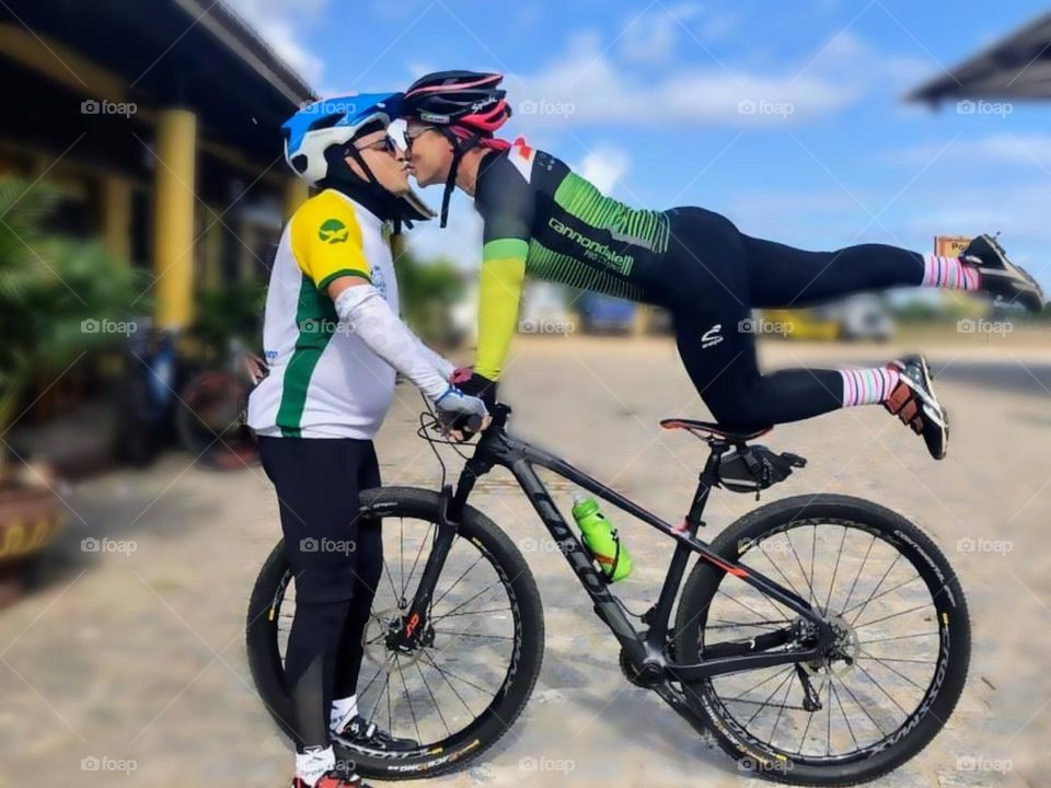 Couple kissing on the bike