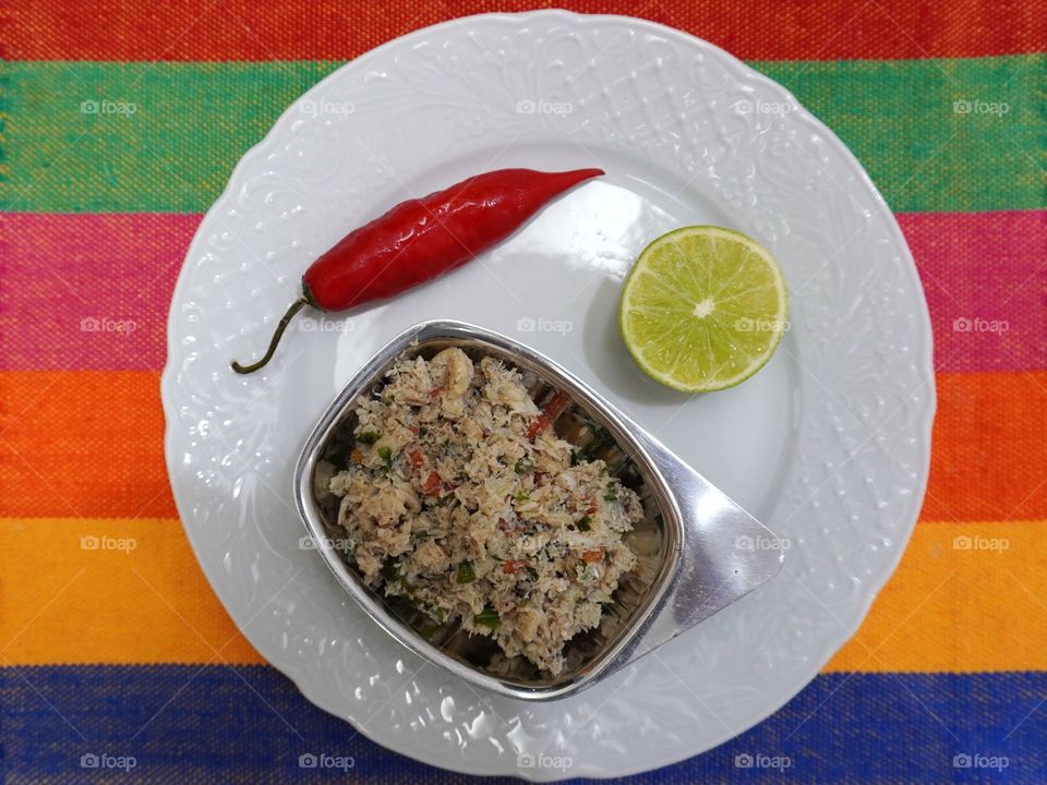 Homemade “Casquinha de caranguejo”: traditional dish of popular Brazilian cuisine that’s widely consumed in coastal regions.It basically consists of sautéed crab meat with other ingredients like olive oil, onions, parsley, tomatoes, pepper and lemon.