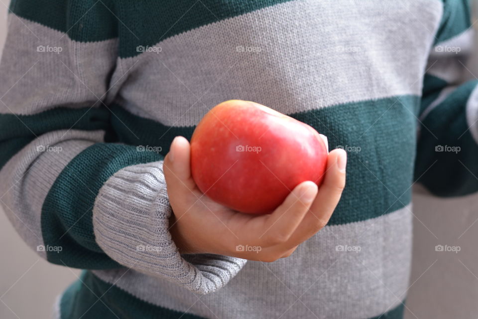 red apple fruit in the hand child