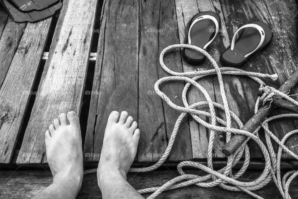 Close-up of bare foot in boat