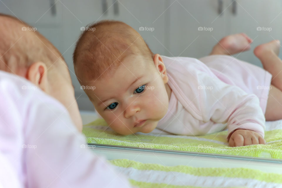 Newborn baby reflection in the mirror