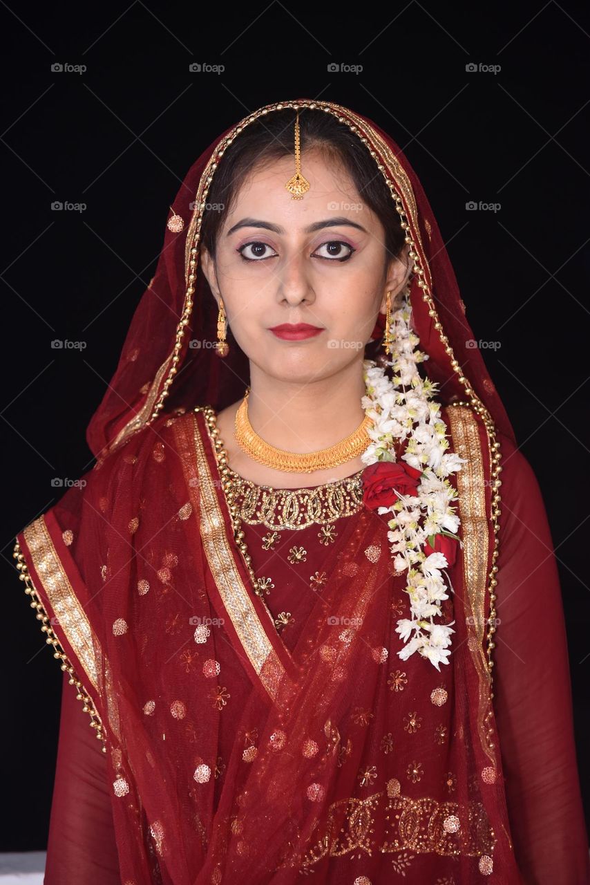 Portrait of a lady wearing heavy gold jewellery