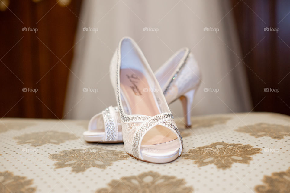 White stilleto Bridal shoes in fron of brides dress
