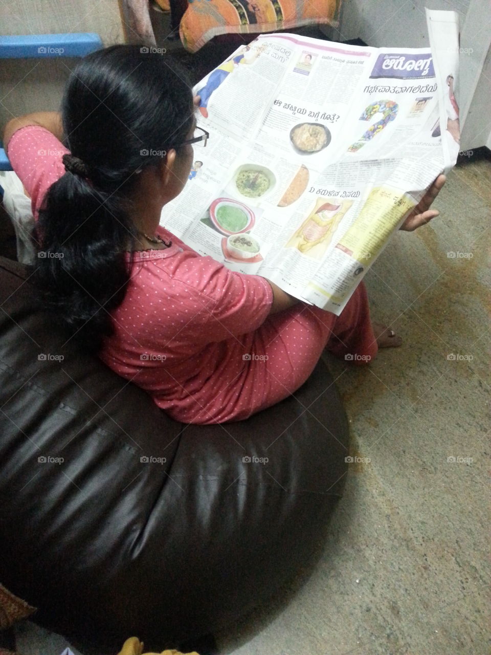 Reading. Lady reading newspaper