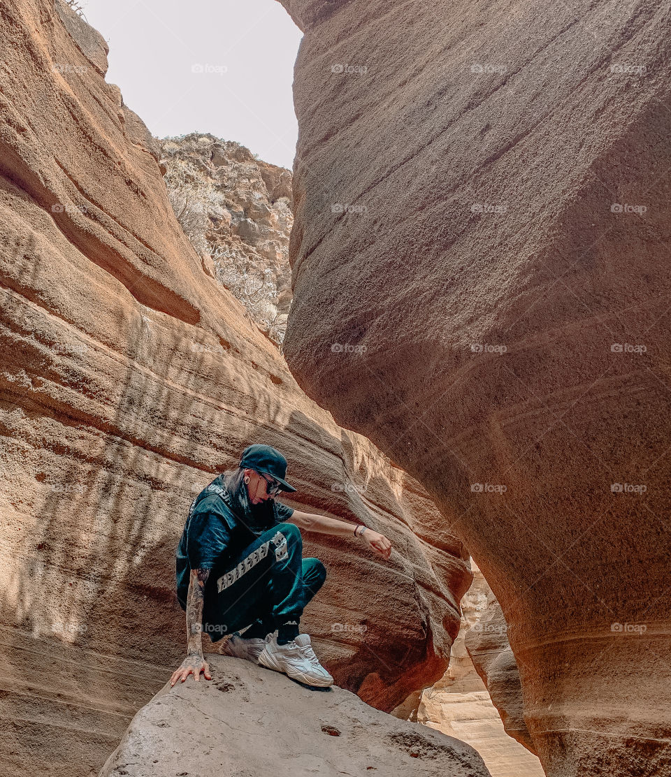 Portrait of a young woman on a rock 