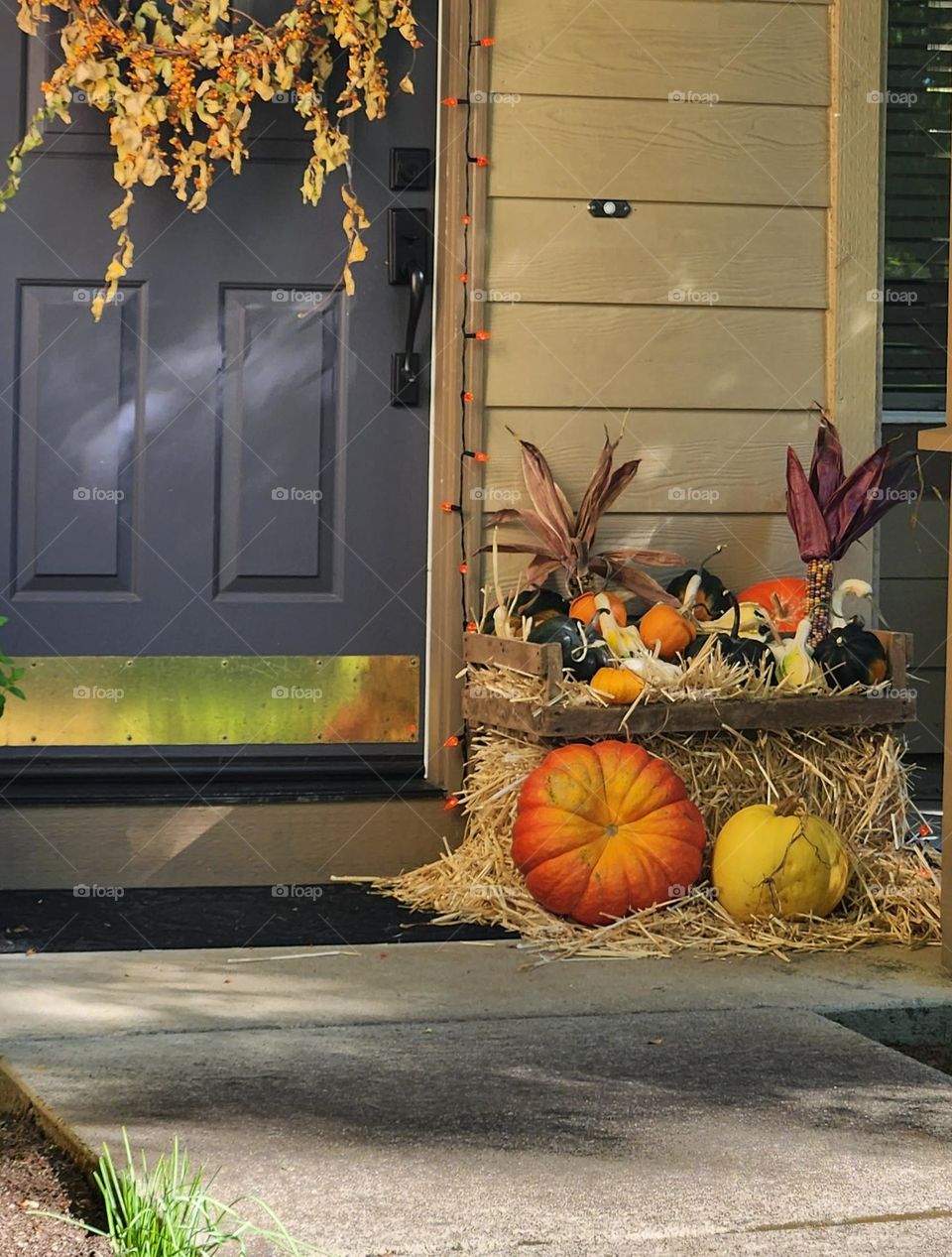 beautiful Autumn harvest themed decor on the front porch of a house in a suburban Oregon neighborhood in October