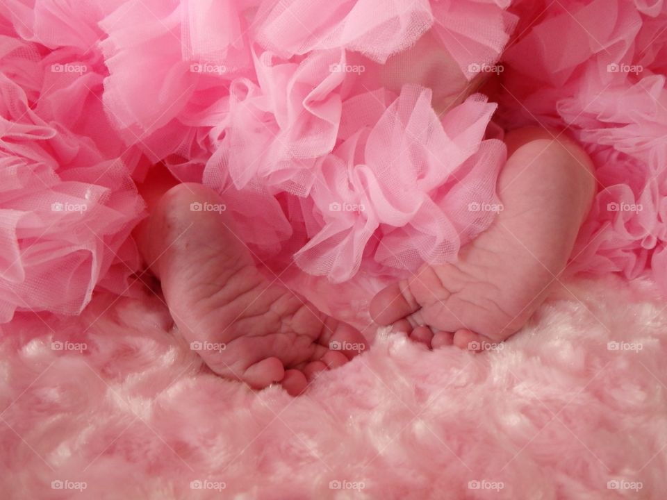 Newborn feet and tutu